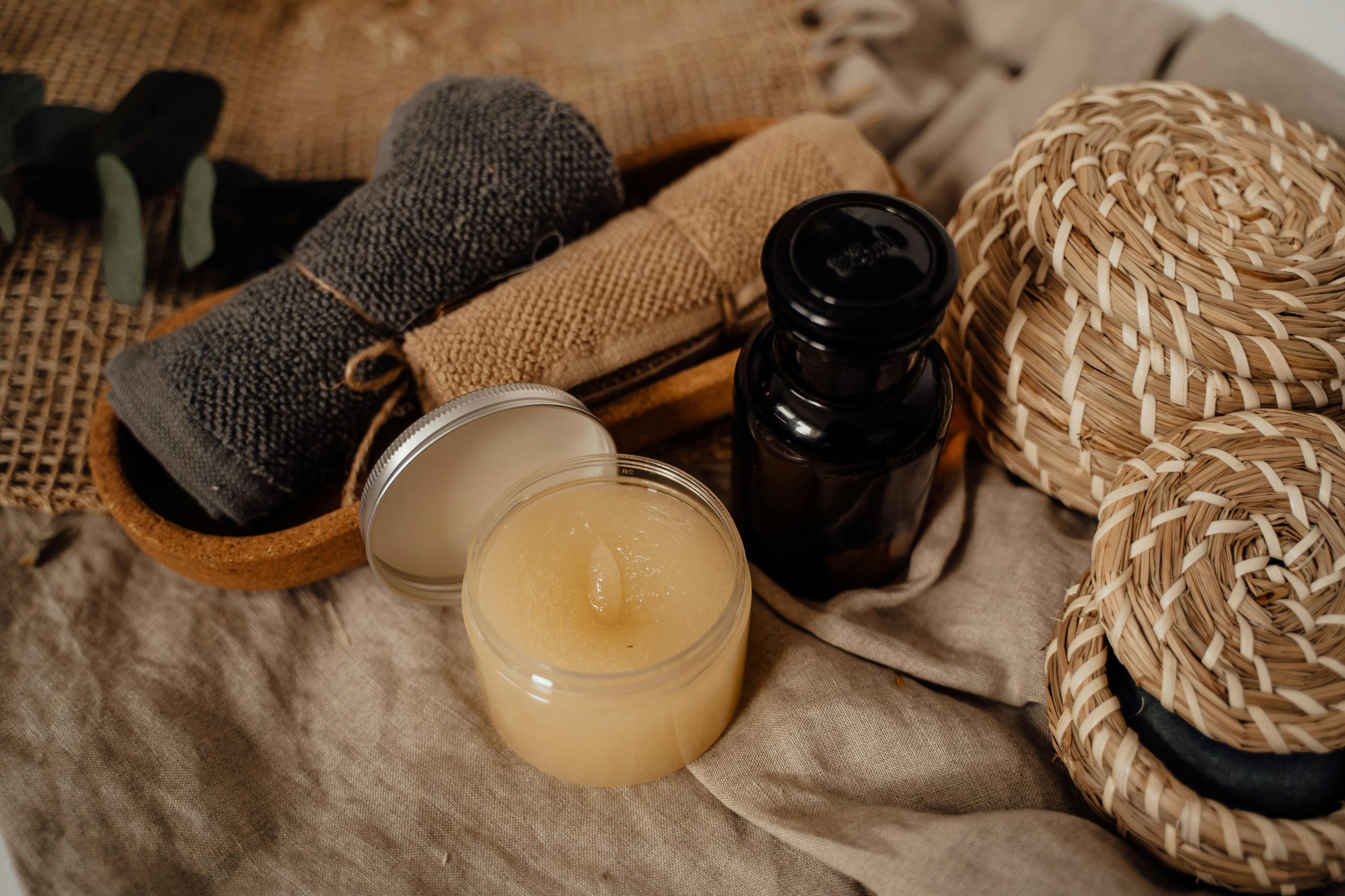 Aesthetic display of skincare essentials with towels and wicker baskets, ideal for relaxation themes.